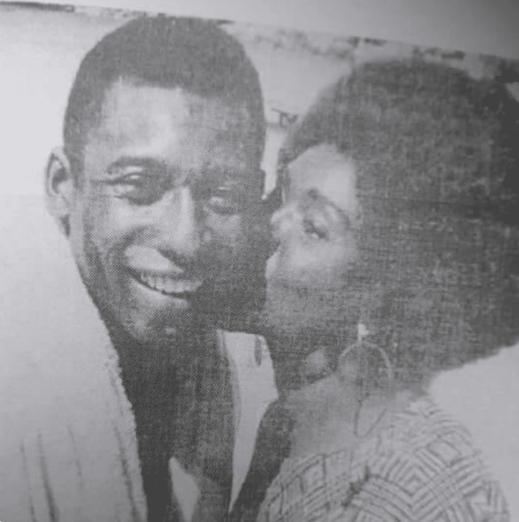 A picture of Togolese musician Bella Bellow kissing Brazilian footballer King Pelle