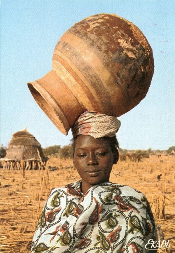 A woman carrying a clay pot on her head